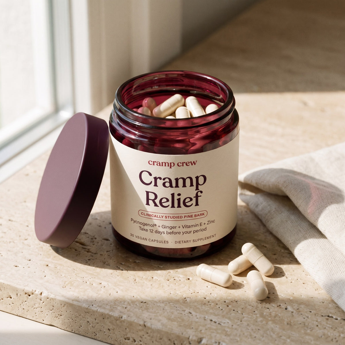 Open jar of cramp crew Cramp Relief with capsules beside it